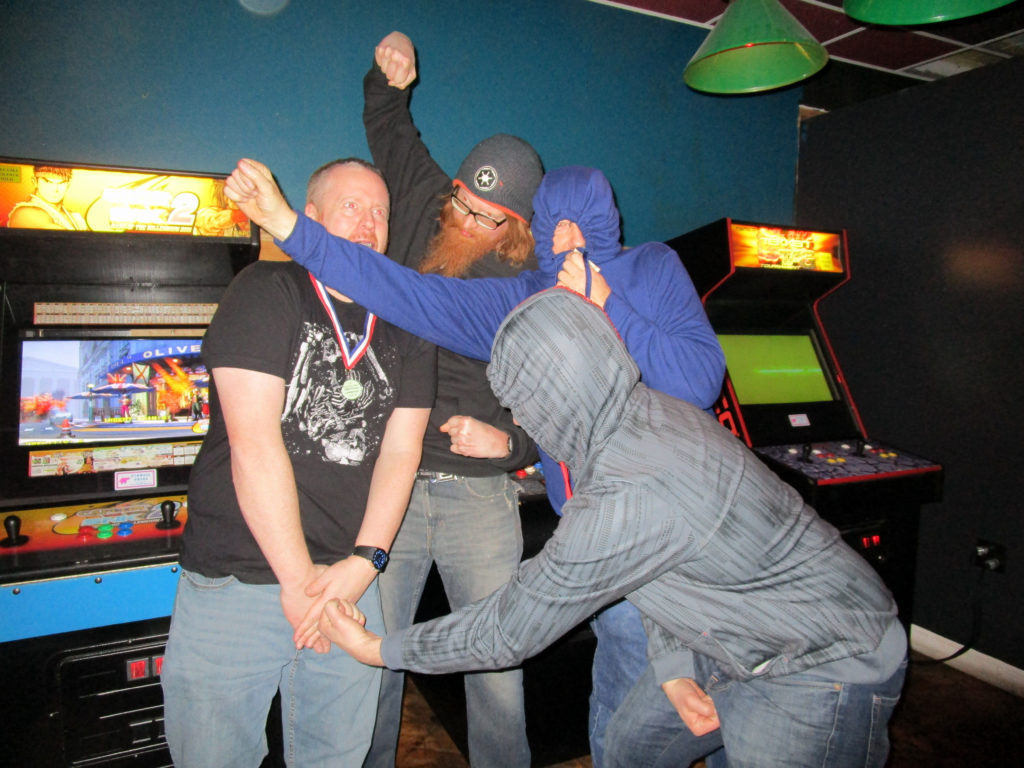 The Smackdown finalists (Bryan, Derik, and Danny) beat up the winner, Mike.