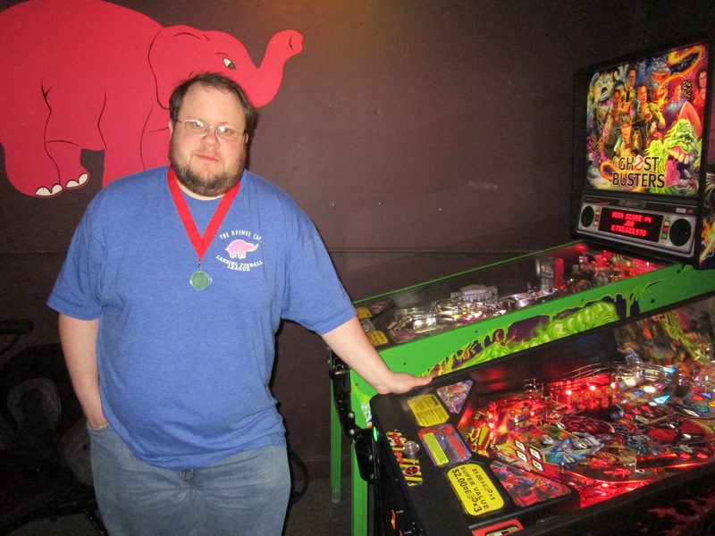 Tim posing with his medal.