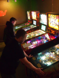 Jason and Mike, both playing pinball.