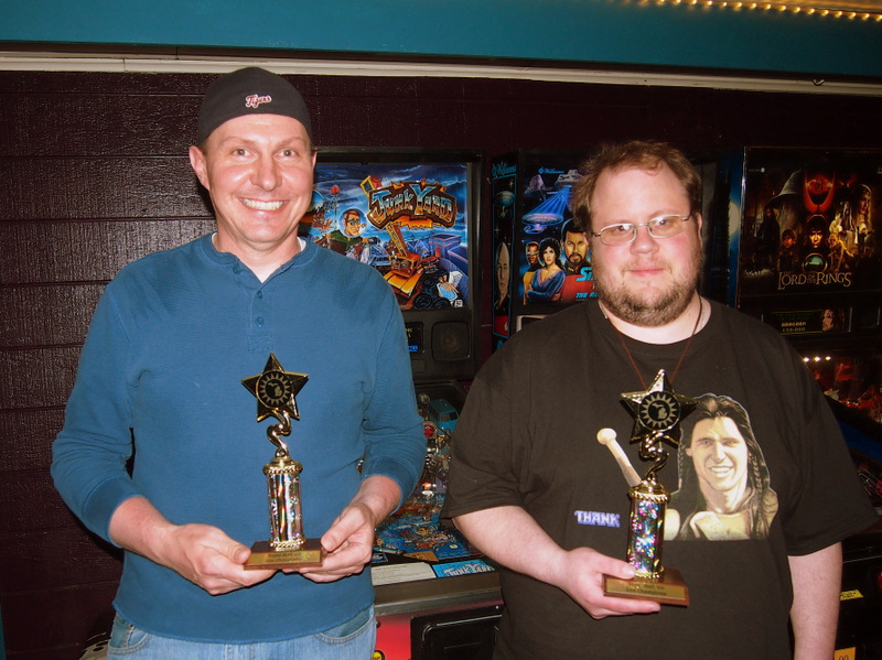 Mike and Tim holding trophies in front of Junk Yard.