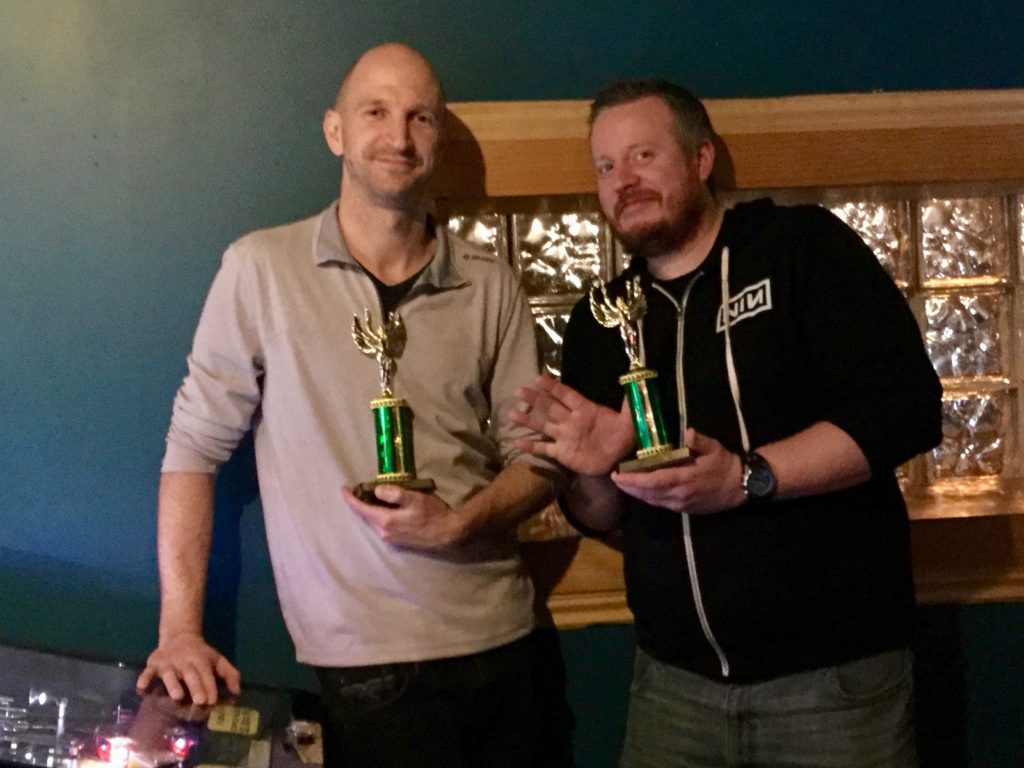 Josh and Mike holding up trophies.